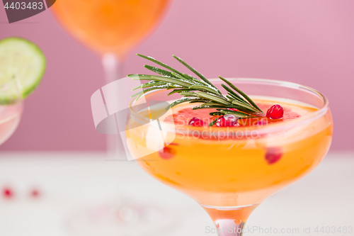 Image of The rose exotic cocktails and fruits on pink