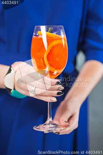 Image of The exotic cocktail and female hands