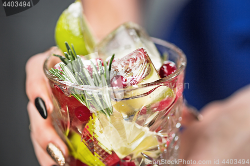 Image of The exotic cocktail and female hands