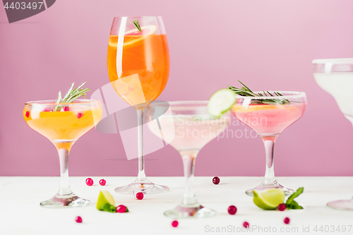 Image of The rose exotic cocktails and fruits on pink