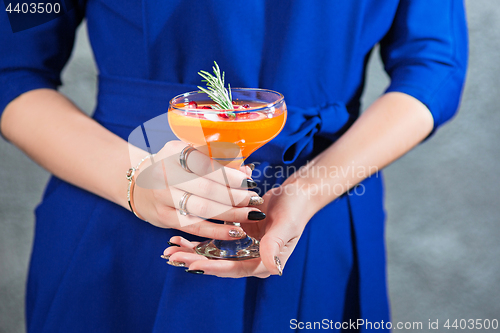 Image of The exotic cocktail and female hands