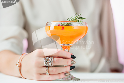 Image of The rose exotic cocktails and fruits and female hand