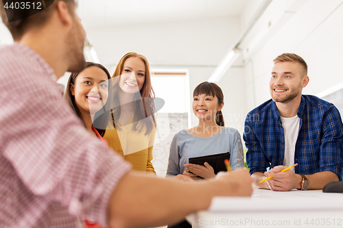 Image of creative team talking at office