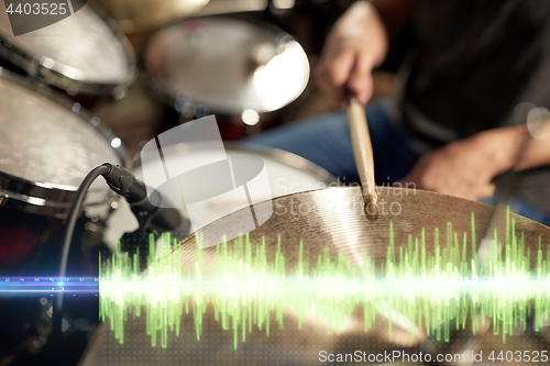 Image of drummer playing drum kit at sound recording studio