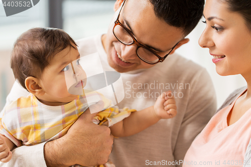 Image of happy family with baby daughter at home