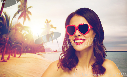 Image of woman with red lipstick and heart shaped shades