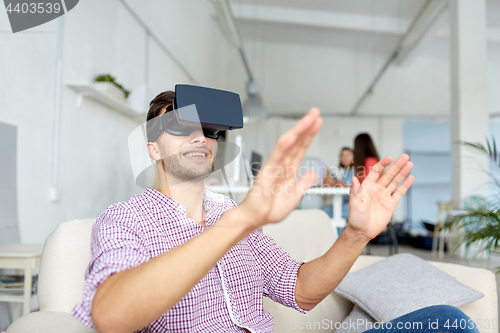 Image of happy man with virtual reality headset at office