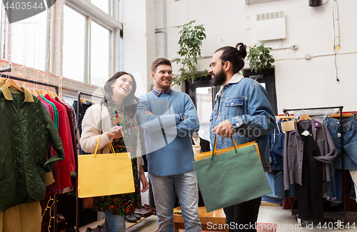 Image of friends shopping bags at vintage clothing store