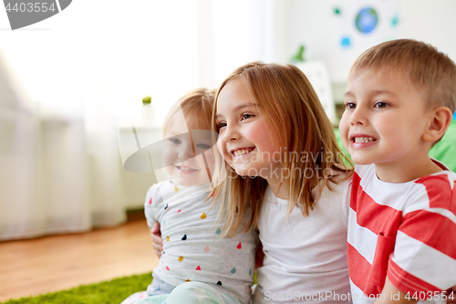 Image of happy little kids hugging at home