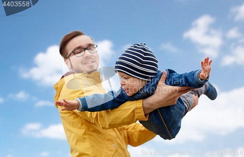 Image of father with son playing and having fun outdoors