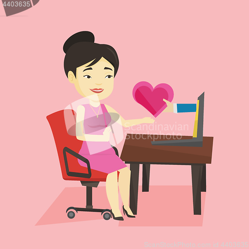 Image of Young woman dating online using laptop.