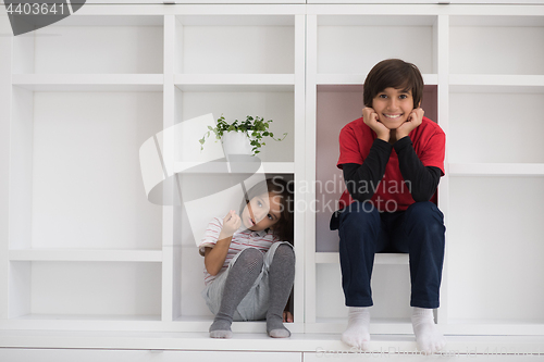 Image of young boys posing on a shelf