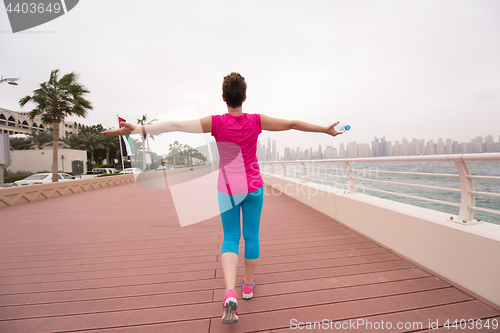 Image of young woman celebrating a successful training run