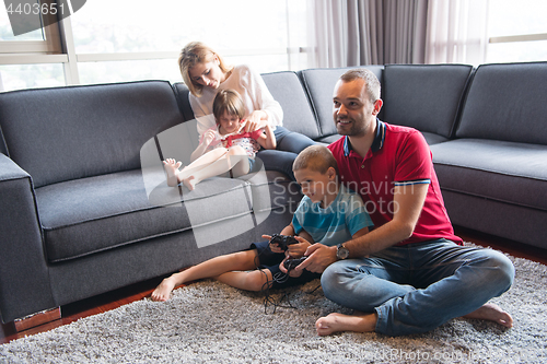 Image of Happy family playing a video game