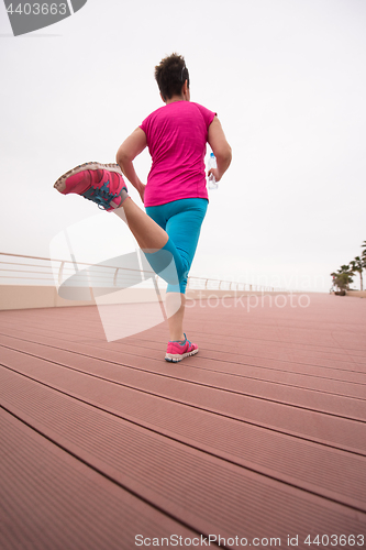 Image of woman busy running on the promenade