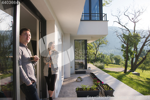 Image of couple enjoying on the door of their luxury home villa
