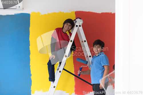 Image of boys painting wall