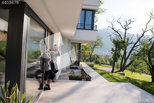 Image of couple enjoying on the door of their luxury home villa