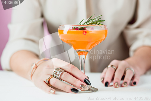 Image of The rose exotic cocktails and fruits and female hand