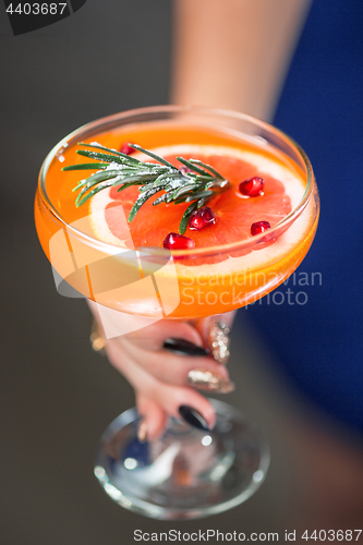 Image of The exotic cocktail and female hands