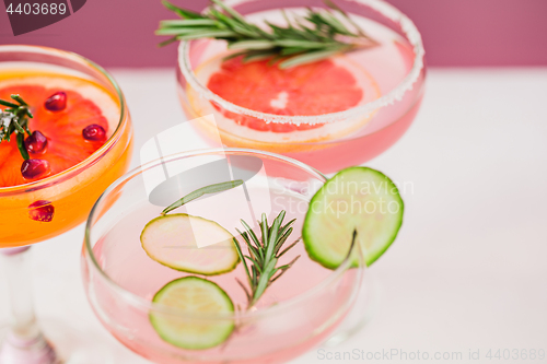 Image of The rose exotic cocktails and fruits on pink