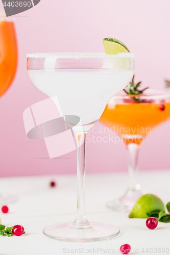 Image of The rose exotic cocktails and fruits on pink