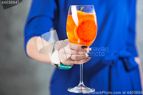 Image of The exotic cocktail and female hands