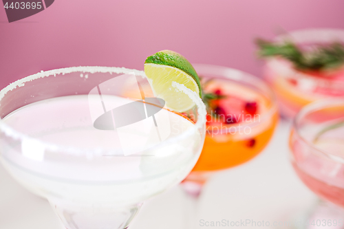 Image of The rose exotic cocktails and fruits on pink