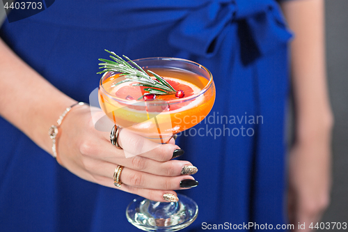 Image of The exotic cocktail and female hands