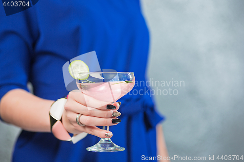 Image of The exotic cocktail and female hands