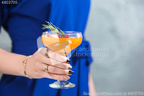 Image of The exotic cocktail and female hands