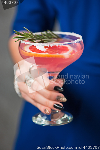 Image of The exotic cocktail and female hands