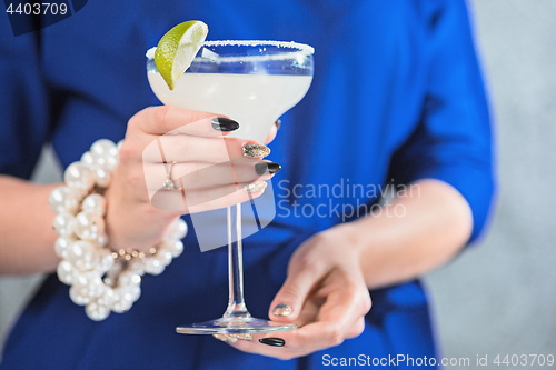 Image of The exotic cocktail and female hands