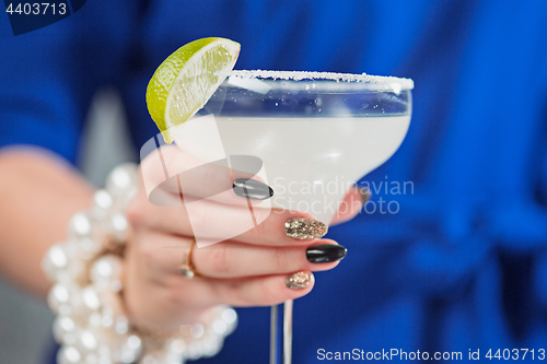 Image of The exotic cocktail and female hands