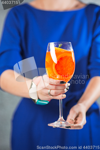 Image of The exotic cocktail and female hands