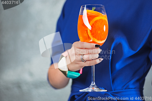 Image of The exotic cocktail and female hands