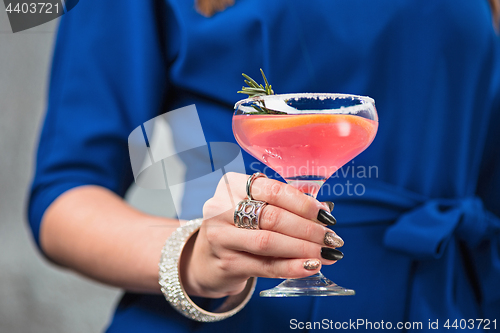 Image of The exotic cocktail and female hands