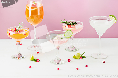 Image of The rose exotic cocktails and fruits on pink