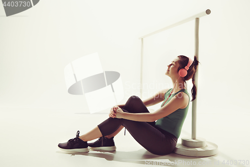 Image of Front view of a young woman sitting with headphones