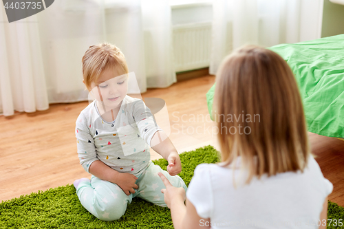 Image of girls playing rock-paper-scissors game at home