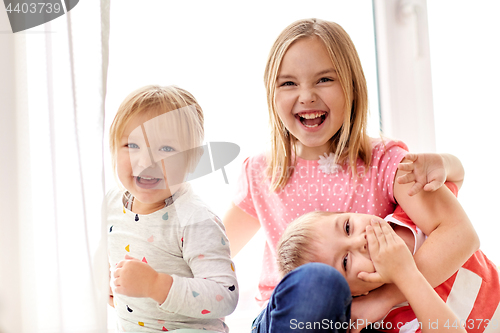 Image of happy little kids hugging at window