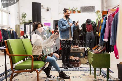 Image of couple choosing footwear at vintage clothing store