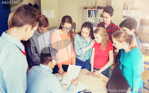 Image of group of students and teacher with tests at school