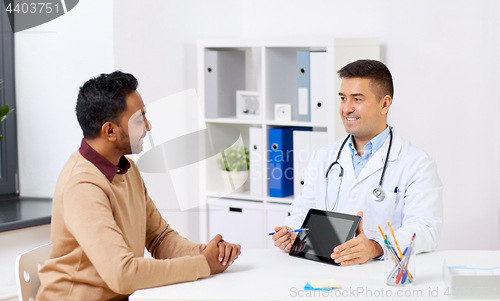 Image of happy doctor with tablet pc and patient at clinic