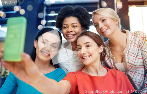 Image of happy young women taking selfie with smartphone