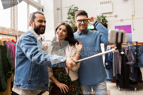 Image of friends taking selfie at vintage clothing store