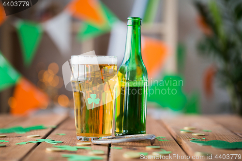 Image of glass of green beer, horseshoe and gold coins