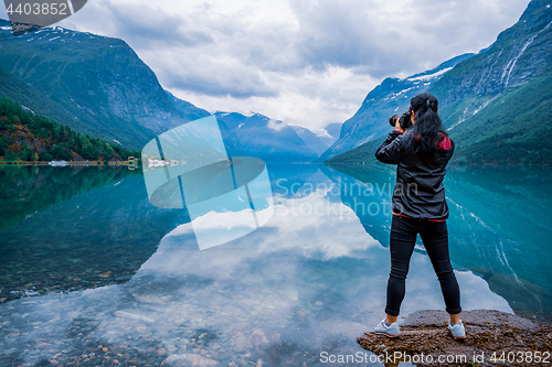 Image of Nature photographer tourist with camera shoots lovatnet lake Bea