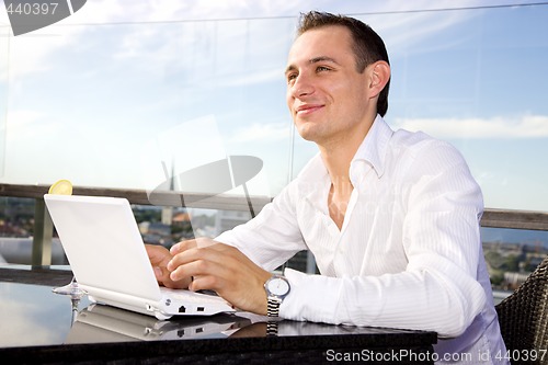 Image of businessman on leisure with laptop