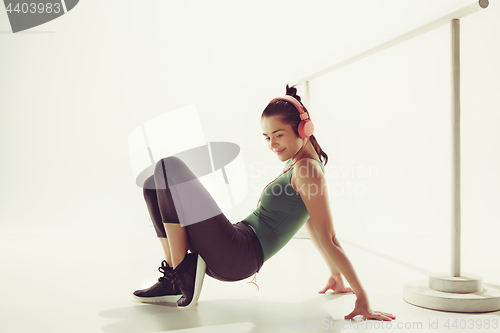 Image of Front view of a young woman sitting with headphones